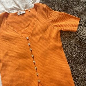 Orange Sandro knit top with silver buttons